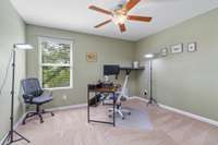 Upstairs Bedroom 3/office with ceiling fan and well kept carpet.