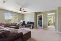 Upstairs Bonus Room with well kept carpet, ceiling fan and lots of natural light flows from 4 bedrooms; This space can be an all purpose room as well.