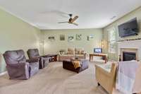 Large Living Room with gas log fireplace and ceiling fan; Flowing from the kitchen and separate Dining Room