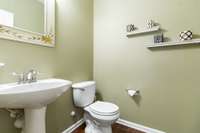 Powder Room downstairs with great decorator colors; tall baseboard and crown molding thru the home.