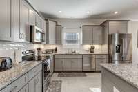 Be sure to check out the upgraded KitchenAide stainless appliance package when you see this home! Even the fridge has woodgrain detail inside.