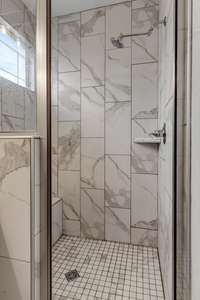 Large walk in shower tiled from top to bottom