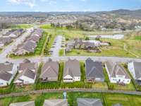 Aerial view shows the most ideally situated home in one of Hendersonville's most desirable communities. Enjoy Millstone's widest street and easy access to the pool, fitness center, and playground. Watching the kids play from your home is a reality!