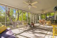 This screened porch will become your favorite place in the home!  With views for miles, the cozy and charming space seamlessly blends the outdoors with the property's warm interior.