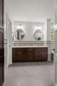 Featuring double vanities, terrific lighting and heated tile floors, this bathroom is a dream:)
