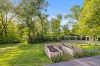 An enclosed and raised herb garden is just off of the end of the driveway.