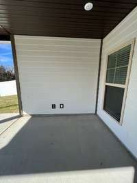 this wall has the cable jack & outlet for the outside tv, ceiling fan & led lights included on the back porch