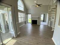 Reverse view of the great room looking to the fireplace and front door.