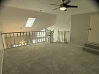 Loft area for multiple uses overlooks the great room.  The skylight provides extra natural light