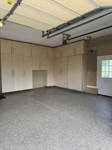 2 car garage with epoxy coated floor and custom floor to ceiling cabinets.