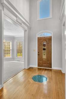 Step into the grand light filled foyer with hardwood floor and custom inlay.