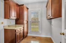 Laundry room with custom cherry cabinets and pantry.