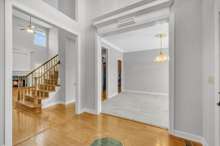 Look at the custom architectural detail above the openings to the living room and formal dining room.