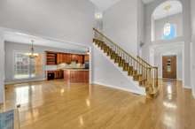 Open hardwood staircase that leads to upstairs bedrooms.