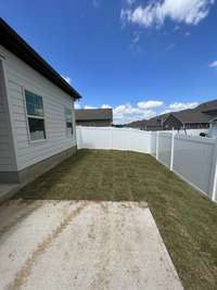 view of the left side of the yard. Builder has installed a privacy fence