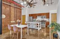 The living area is truly vast with room for dining, office, and multiple seating areas adjacent to the kitchen—fabulous for entertaining. Ceiling fans and cafe lights make for a comfortable and charming space.