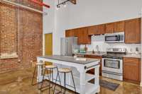 The kitchen includes a pantry and plenty of cabinetry.