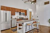The fridge conveys and is practically brand new. The substantial kitchen island with bar seating also conveys.