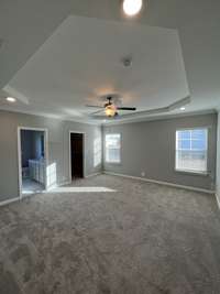 primary bedroom with trey ceiling, ceiling fan, 1-set of led lights, blinds, cable jack