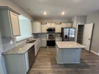 kitchen features are: granite counter tops, ceramic tile backsplash, under cabinet lights, complete S/S appliance package (all 4-pieces) pantry, island,