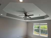 Tray Ceiling in Primary Suite  *COLORS AND SELECTIONS VARY, HOME PICTURED IS AN EXAMPLE OF THE FLOORPLAN NOT THE ACTUAL HOME*