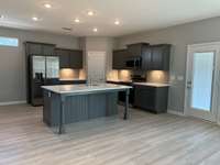Kitchen with Island  *COLORS AND SELECTIONS VARY, HOME PICTURED IS AN EXAMPLE OF THE FLOORPLAN NOT THE ACTUAL HOME*