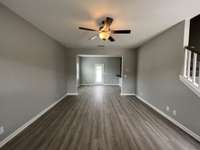 great room looking into the dining room. great room with laminate flooring