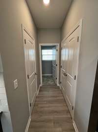 this hallway off of the kitchen leads to the pantry, powder room, laundry room