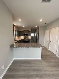 eat-in bar top located between dining room and kitchen. Dining Room with laminate flooring