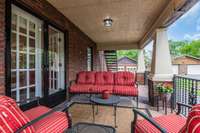 Covered side porch off your living room is perfect for relaxing or entertaining!