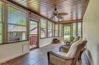 Glass sun porch located at the back of the house off of the kitchen is a great spot to relax year round!