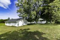 Large detached concrete floored and electricity garage with roll doors and workshop area.  Also features some storage room as well.