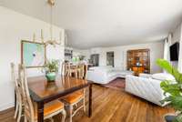 Enter into the dining area which flows into the living room and kitchen.