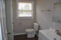 The bathroom is completely remodeled with new fixtures and flooring.