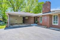 Two-car carport with storage access to backyard and side entrance into home