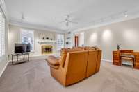 Gathering Room w/new carpet, decorative fireplace, plantation shutters. built-in bookcases