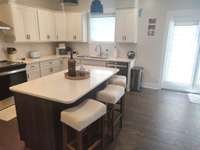 another view of Kitchen w/island. French doors lead to the deck