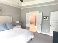 another view of Primary Bedroom showing entry into bathroom