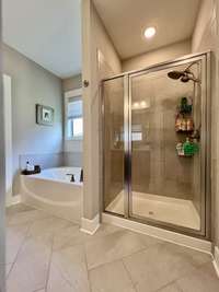 Primary tile Shower and garden tub, tile floor