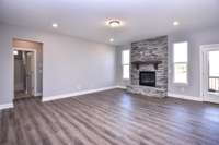 Spacious Great Room with stone fireplace. Fireplace with different looks is an option! Photo is not actual home.
