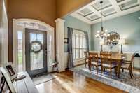 Gorgeous entry foyer with soaring ceilings and coffered ceilings in the dining room!