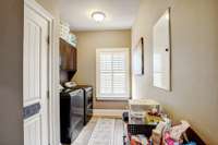 Laundry room with built in cabinet storage and the pantry is located in the laundry room