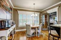 Breakfast nook overlooks the expansive back yard! This lot is just over half an acre! This room beautifully showcases the millwork that you'll find throughout the home!