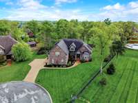 Drone view of the front of the home and the perfectly manicured lawn!