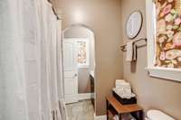 Shared tub/shower-Shower has tile surround! The sink/vanity for bedroom #3 is straight ahead.