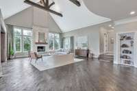 The fireplace & chimney are made from the same Chardonnay stone used in the arches & stonework at the front of the home. Also note the glistening, light-reflecting nature of the scraped hardwood floors, adding more welcome natural light to each room.