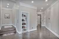 The built-in bookshelf looks sturdy and permanent, but it slides to the side on hidden hinges to expose a secret passageway that leads directly to a lower level recreation room!