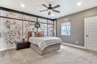 This bedroom is larger than average & features an eclectic faux brick wall that contains a secret door. Also note the custom privacy shades on each window for after-hours.