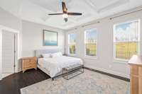 Owners suite main level, back of home,  CUSTOM Coffered ceiling, hard wood floor