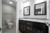 Second full bath w/custom cabinets, soft close doors and drawers.  Granite tops.
